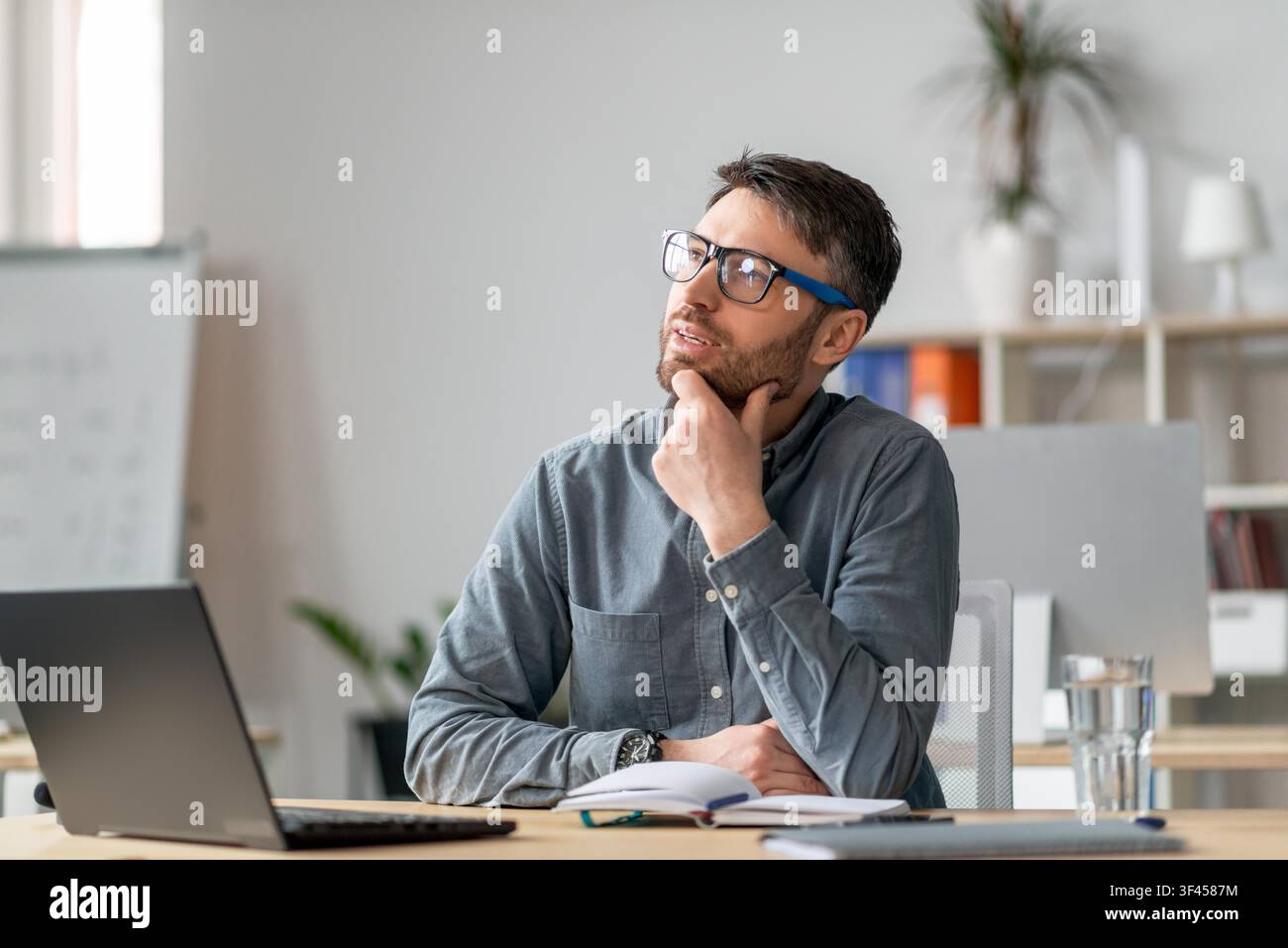 Thoughtful Caucasian Man Wearing Glasses In Office, Thinking About Ideas, Business Concept Stock Photo