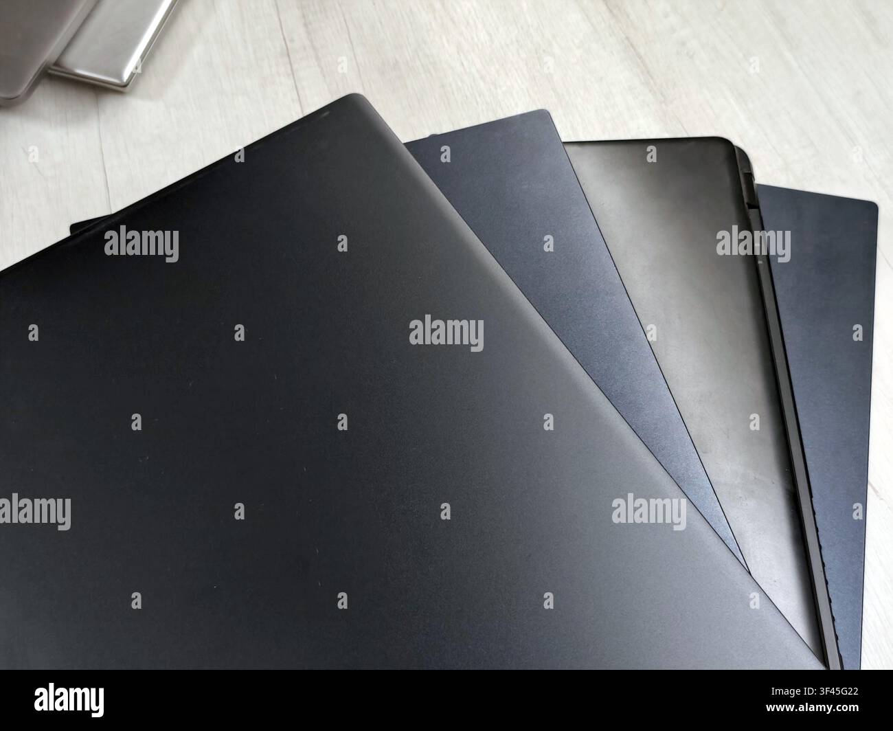 stack of laptops on a gray background, on the table, laptop computer, tablet, business, work, remote work, freelance. Stock Photo