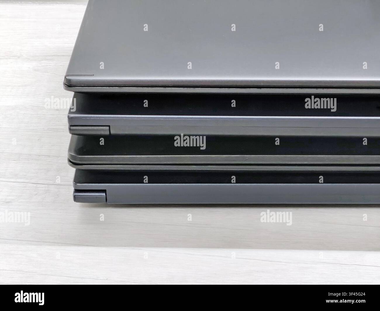 stack of laptops on a gray background, on the table, laptop computer, tablet, business, work, remote work, freelance. Stock Photo