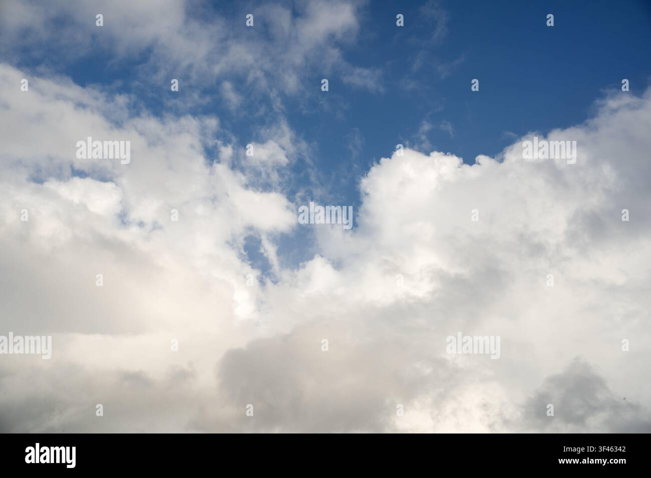 Dramatic tropical cloud formation with bright blue sky opening, natural weather background ideal for atmospheric and climate concepts. Stock Photo