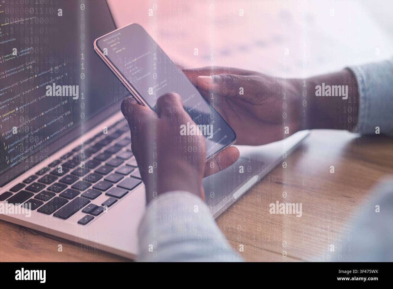 Mobile Security Concept. Black man using phone and laptop Stock Photo