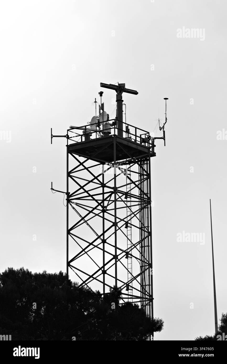 Metal communications tower with a muted sky background Stock Photo