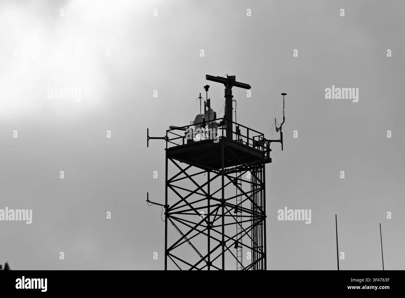 Metal communications tower with a muted sky background Stock Photo