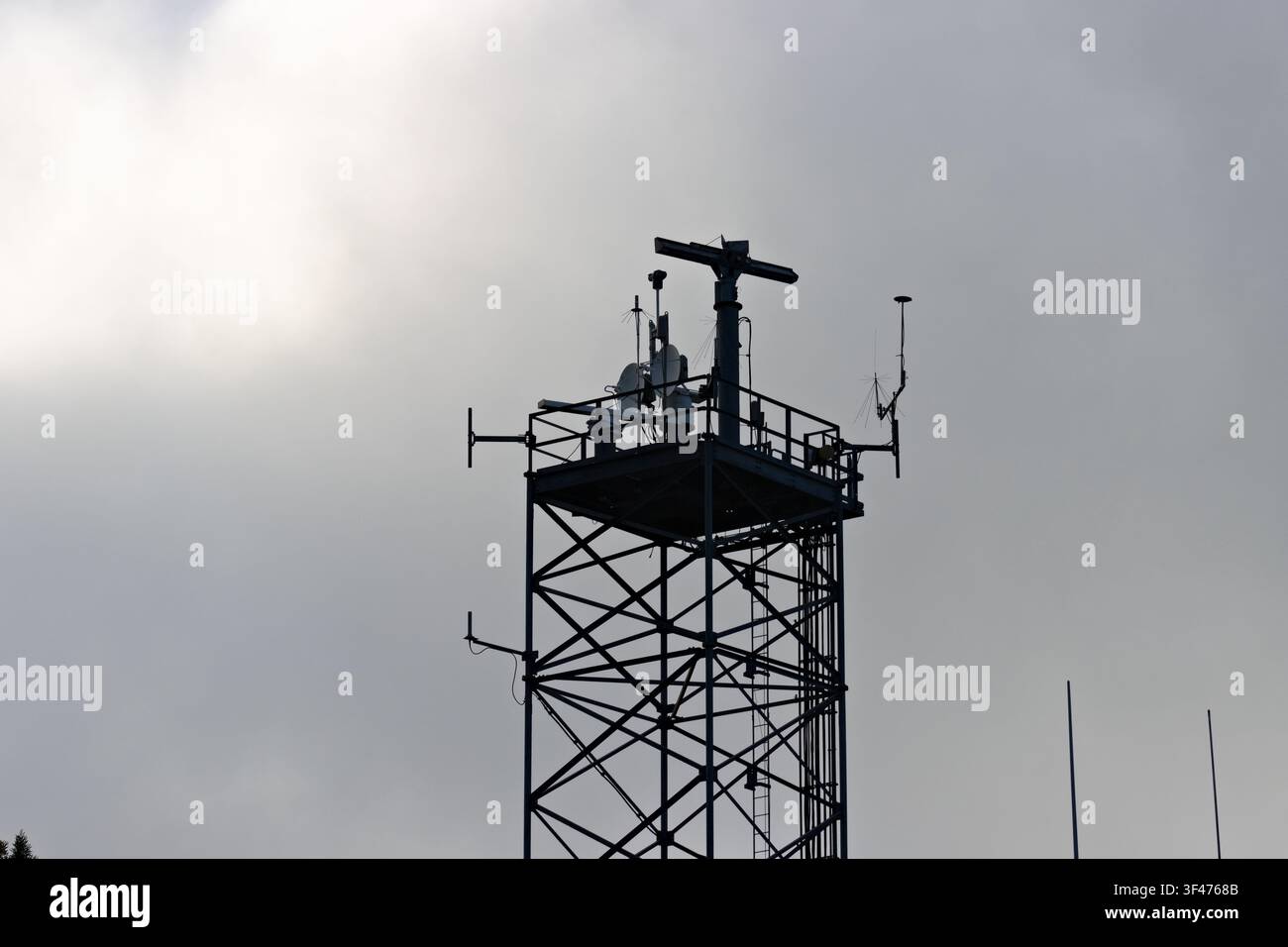 Metal communications tower with a muted sky background Stock Photo