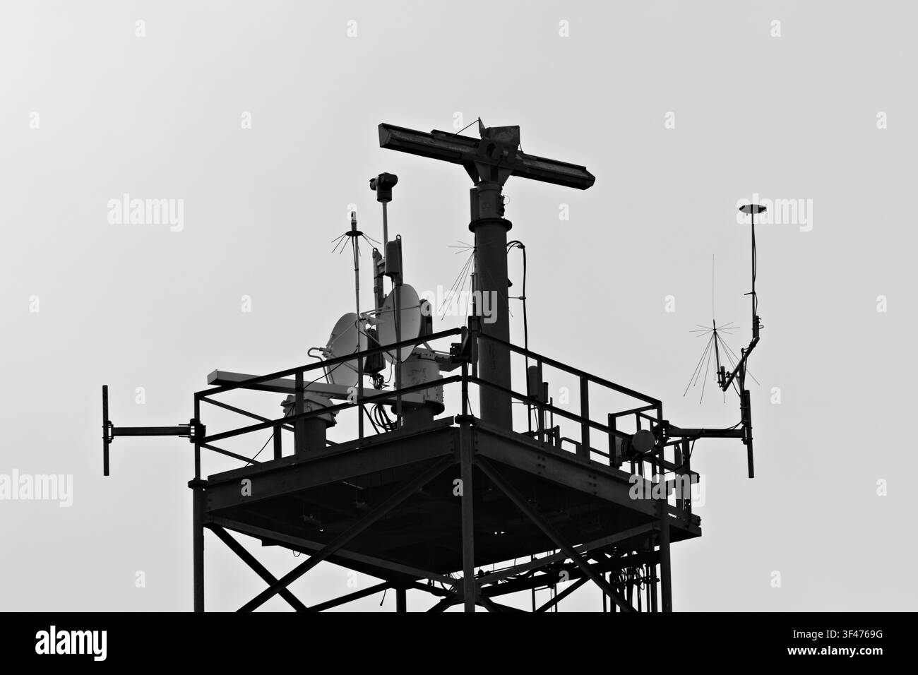 Metal communications tower with a muted sky background Stock Photo