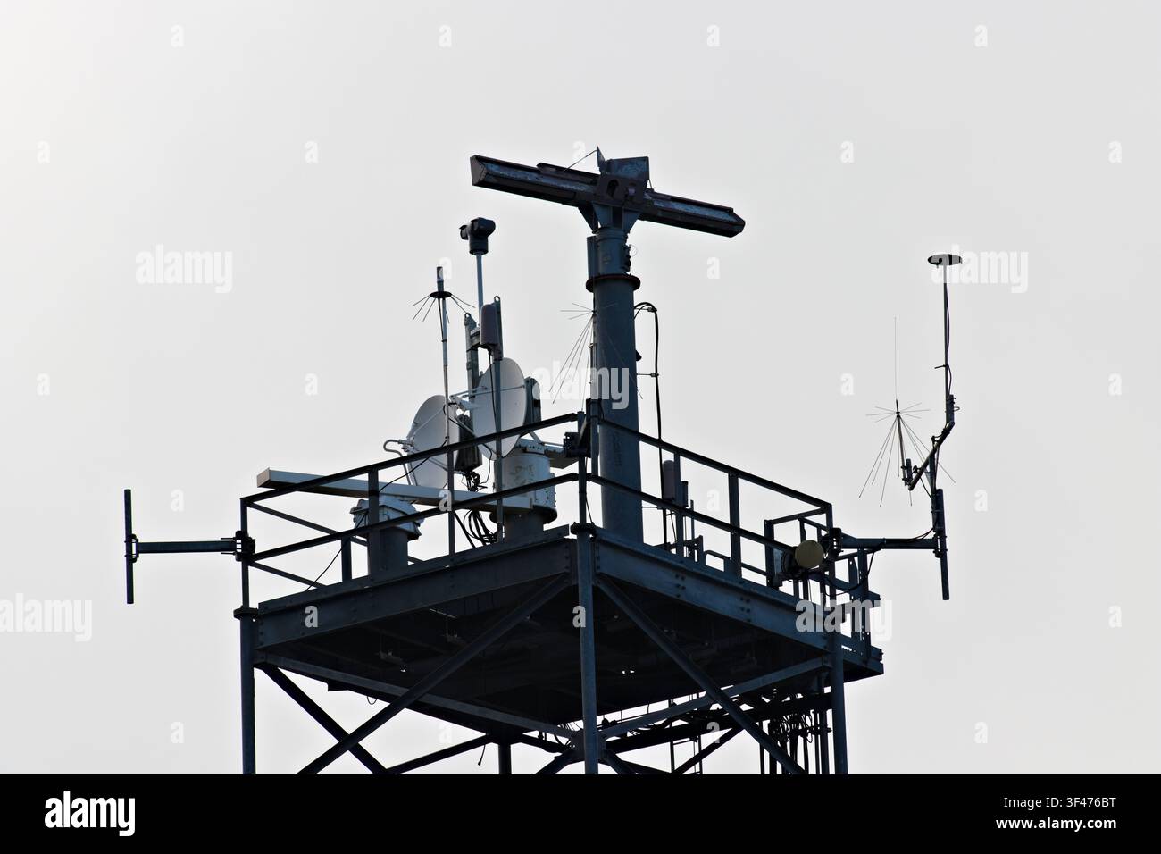 Metal communications tower with a muted sky background Stock Photo