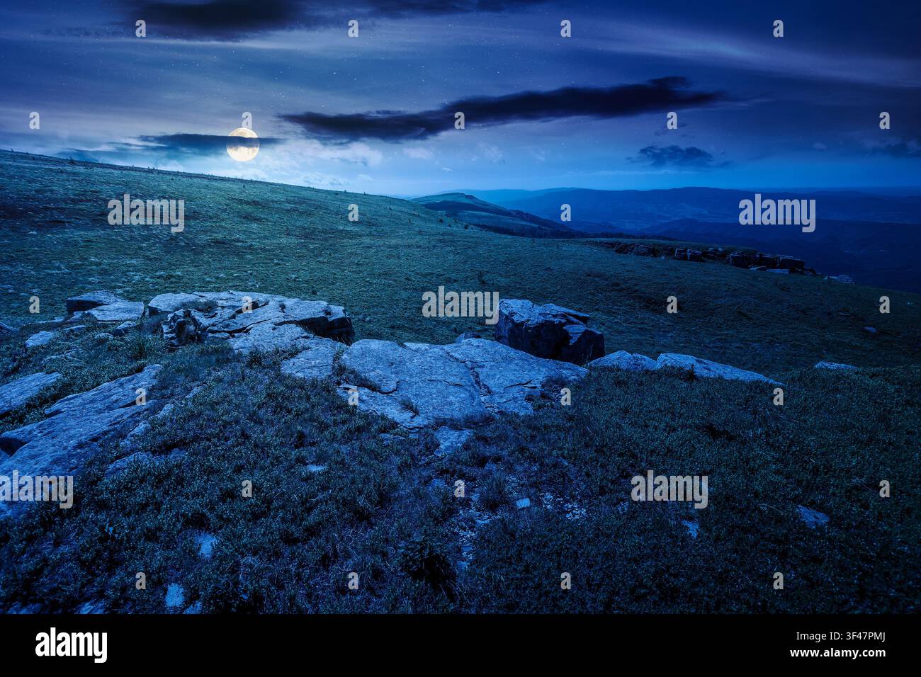 carpathian mountain landscape on summer night. mysterious background for outdoor adventure in the dark. transcarpathia green hill with rocks in foll m Stock Photo