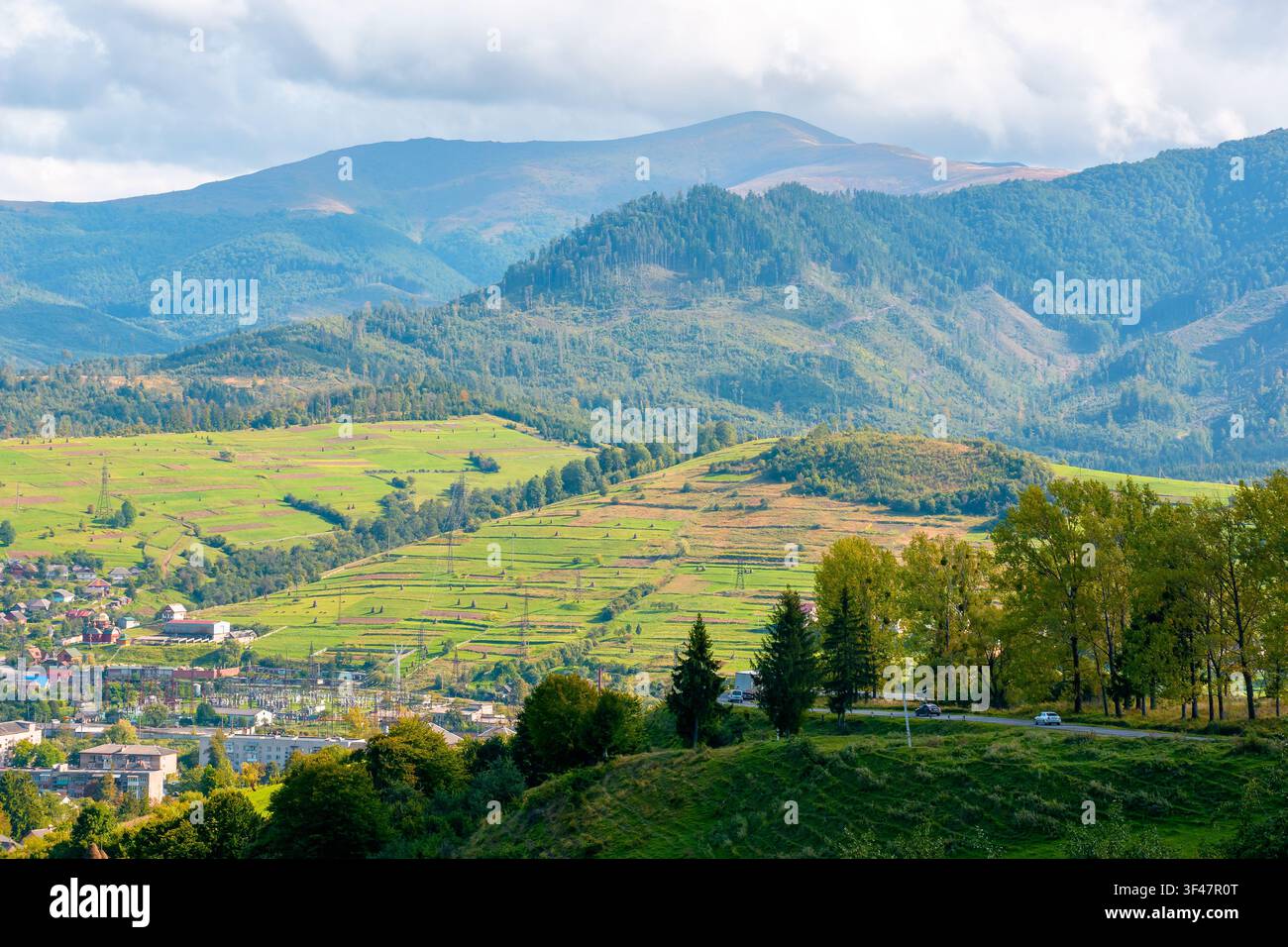 countryside mountain landscape in autumn. scenic rural area of ukraine in fall season. mountain path to volovets town in the valley. sunny afternoon Stock Photo