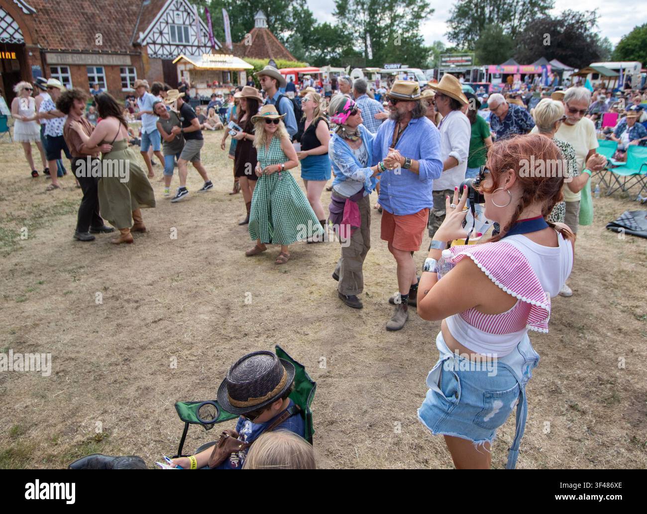 Audience by the main stage dancing at the 19th Maverick long weekend Americana music festival held in Easton Farm Park in rural Suffolk. Stock Photo
