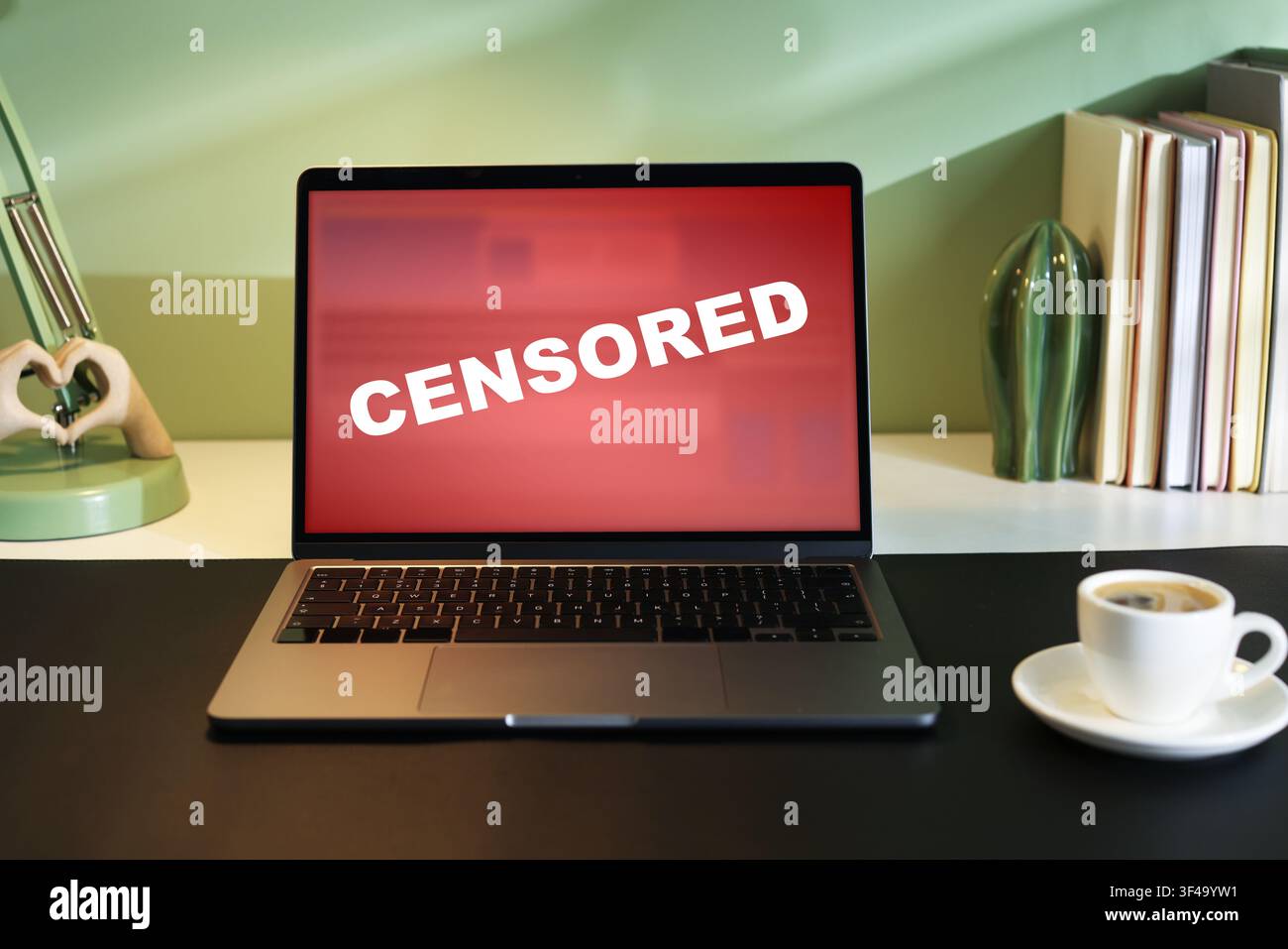 Censored content. Laptop displaying notification on desk Stock Photo
