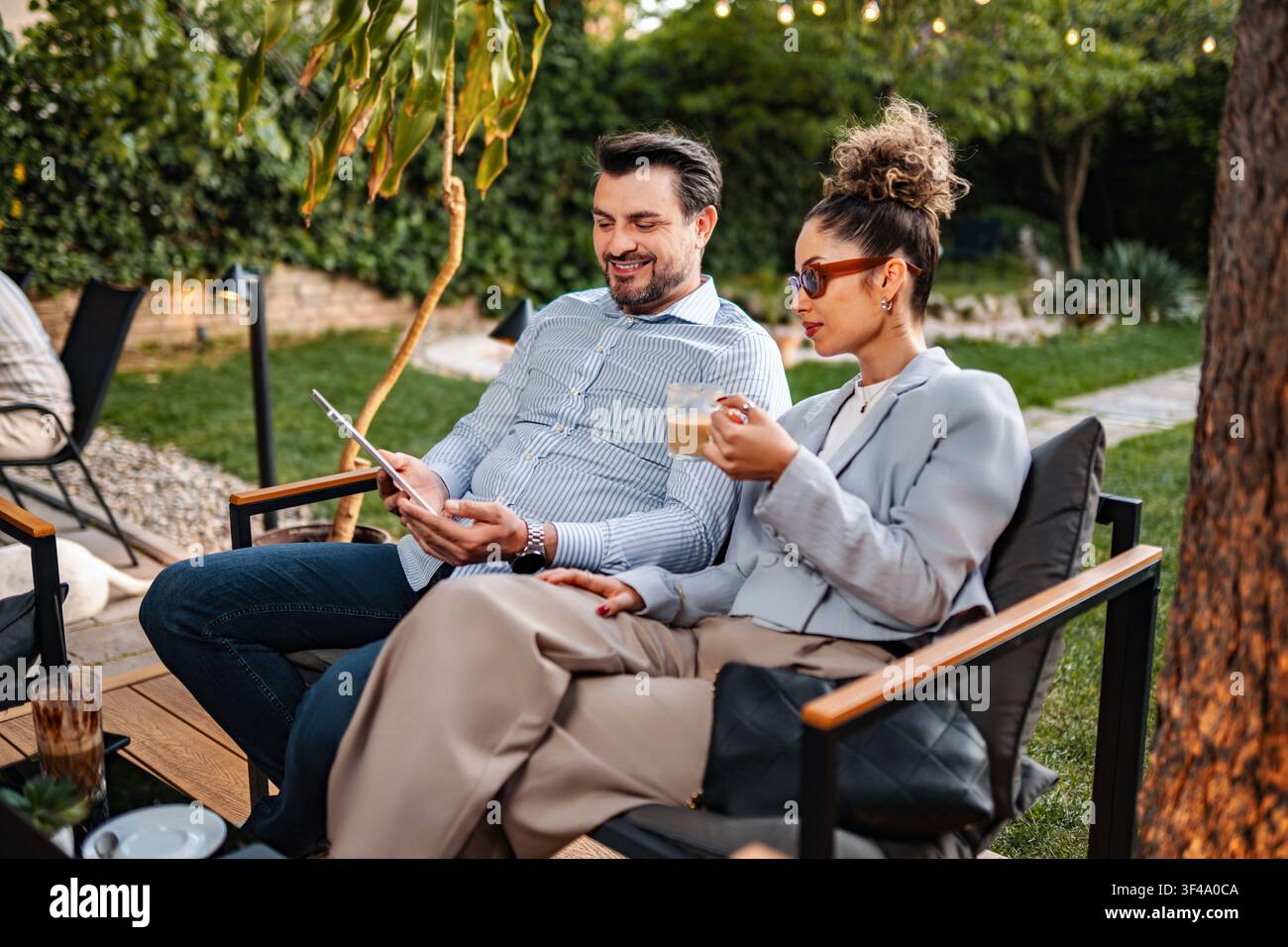 Business colleagues discussing project ideas using digital tablet outdoors Stock Photo