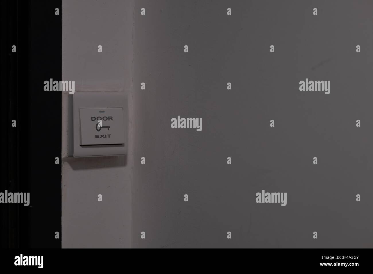 Door exit switch mounted on wall with copy space for access control concept Stock Photo