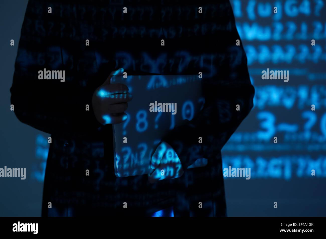 Hacker with laptop and projection of programming code in dark room, closeup Stock Photo