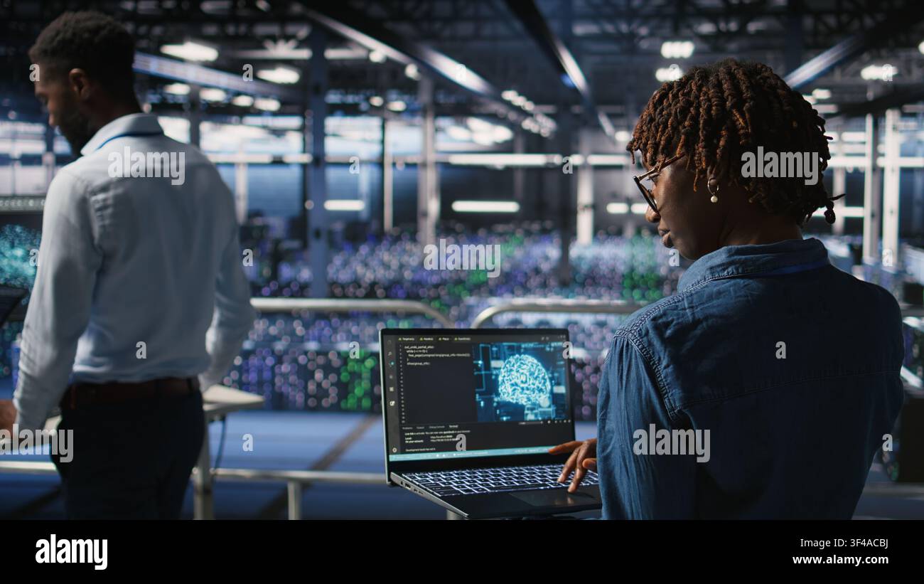 Data center coworkers doing maintenance on mainframes handling AI processing tasks. Server hub system administrators managing storage arrays supporting deep learning training workflows, Stock Photo