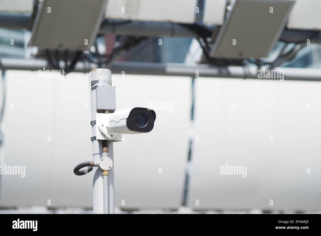 CCTV camera monitors activity in urban area Stock Photo