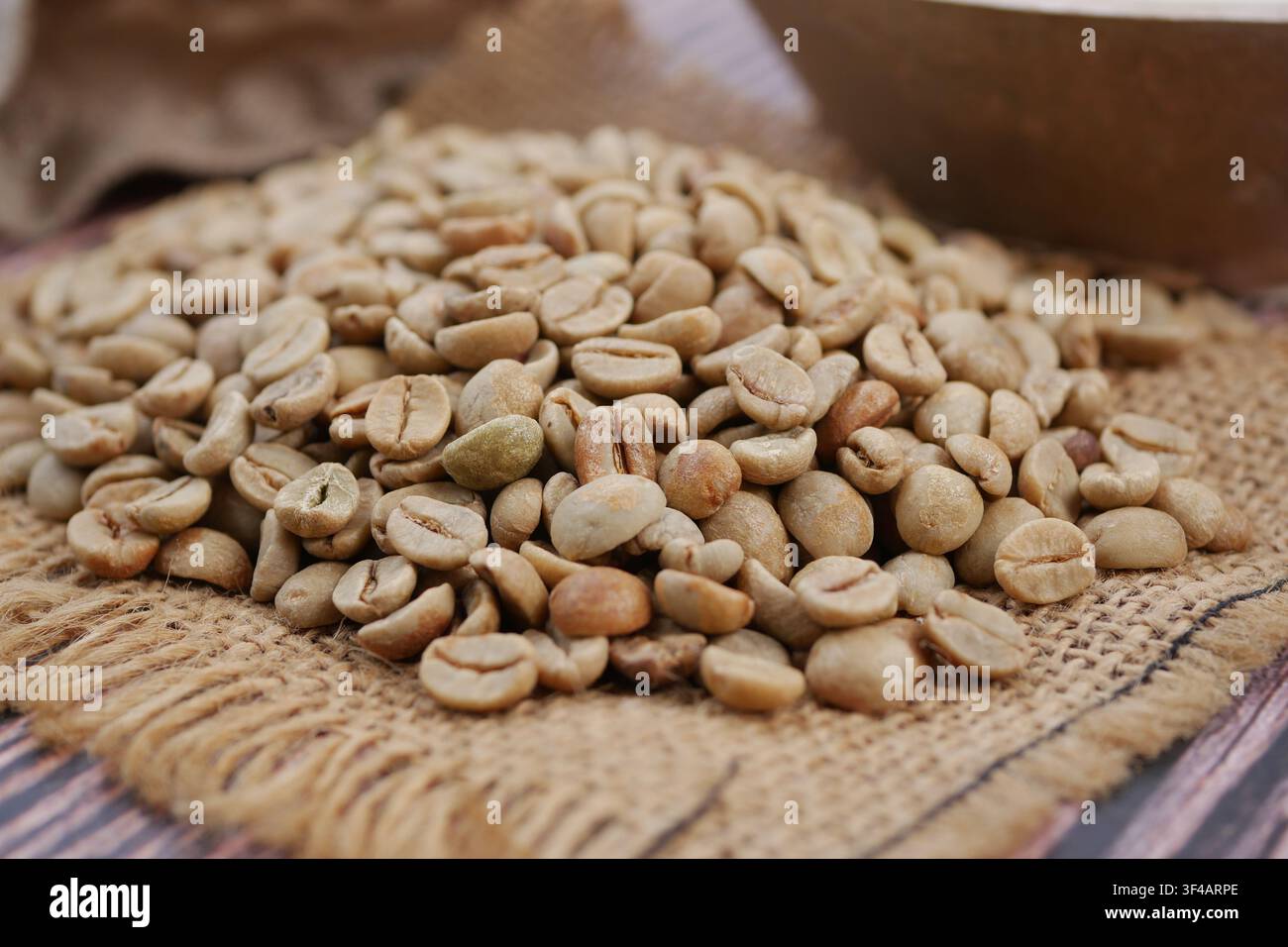 Coffee beans on burlap in a market setting Stock Photo