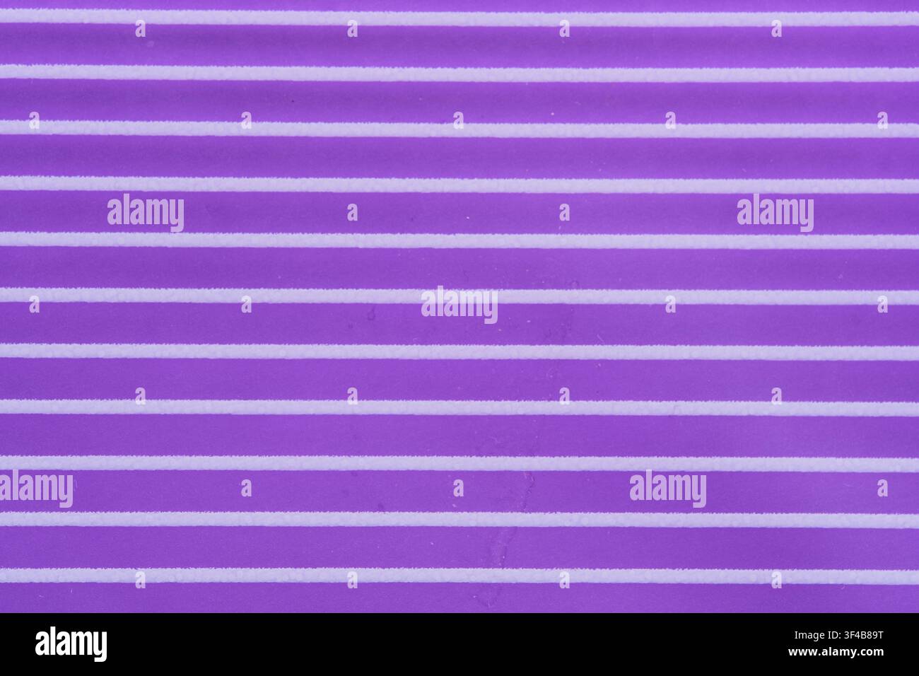 Abstract purple textured background featuring horizontal white parallel lines and ribbed surface Stock Photo
