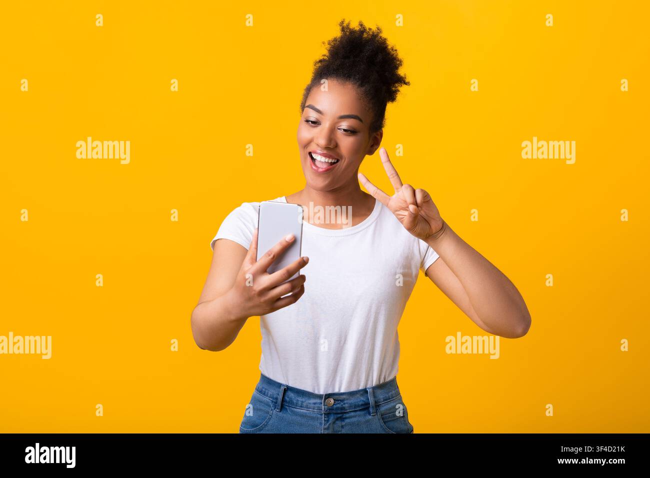 Happy black lady taking selfie using mobile phone Stock Photo