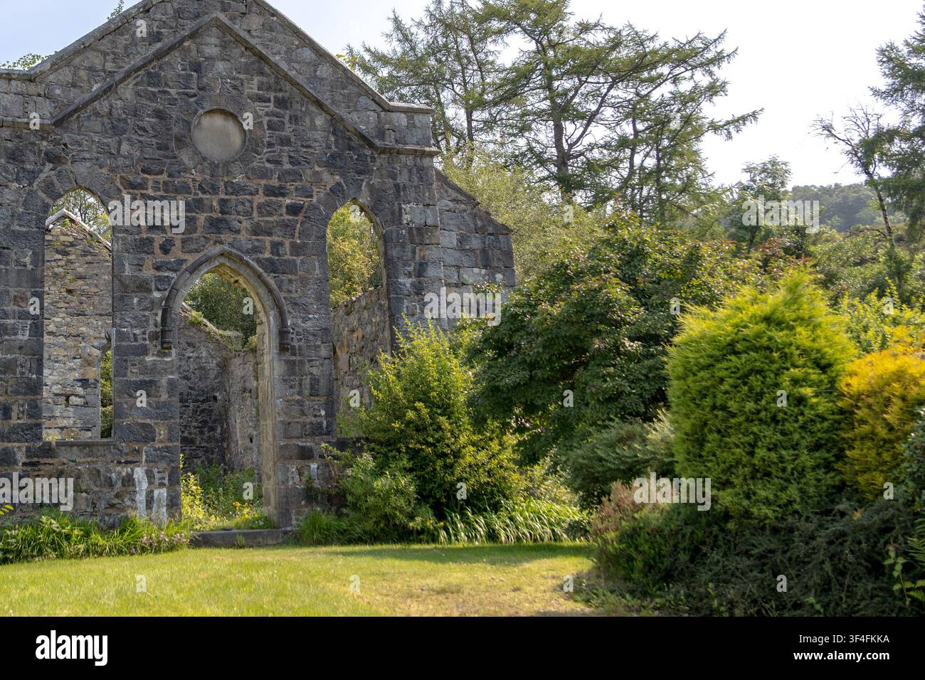 Abandoned Roofless Church Ruins Overgrown with Vegetation Stock Photo