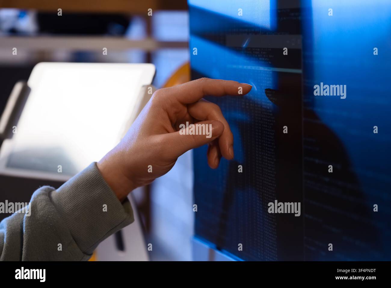 Female programmers hand testing code on computer in office at night, closeup Stock Photo