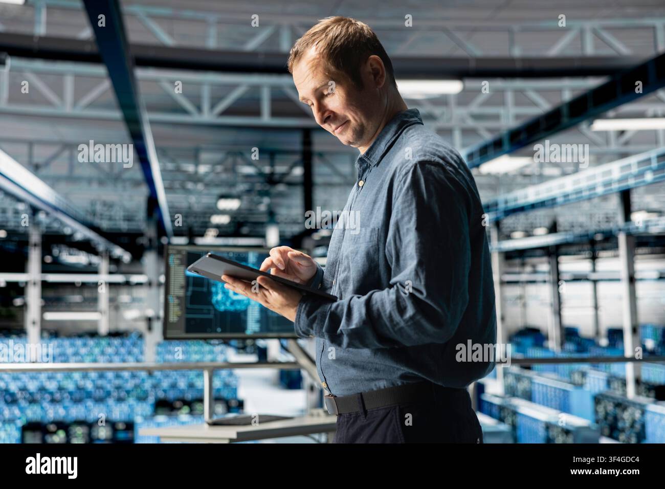 System administrator using tablet in in data center maintaining infrastructure for AI workloads. IT professional in server farm utilizing high tech server clusters for parallel AI processing Stock Photo