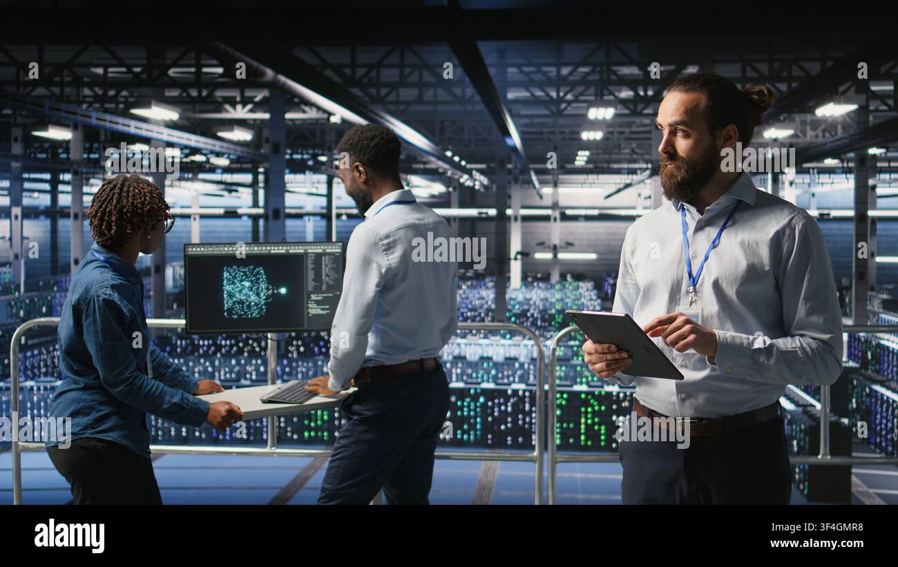 Technicians on data center platform using devices to monitor neural network LLM visualization. Industrial server hub engineering team overseeing rigs powering machine learning processes, Stock Photo