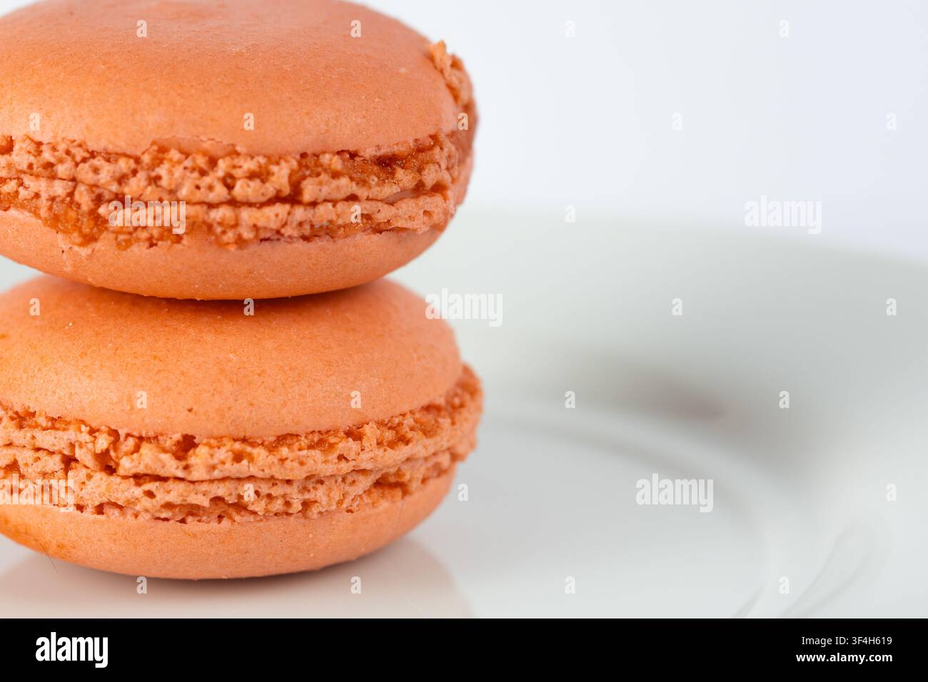 Orange Macarons Isolated on White Background Stock Photo