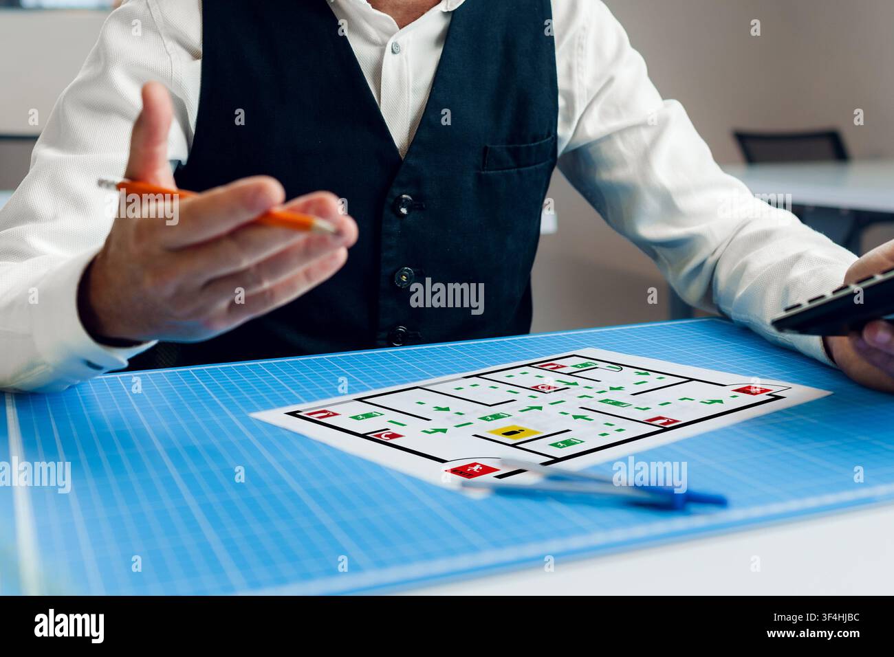 Emergency evacuation plan displayed on table during planning session Stock Photo