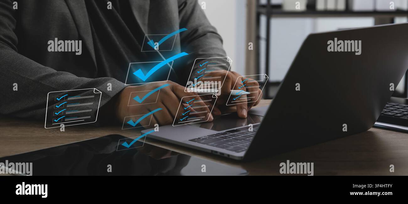 Business professional using laptop with digital checklist interface for document management, document online approval, file verification, document pap Stock Photo