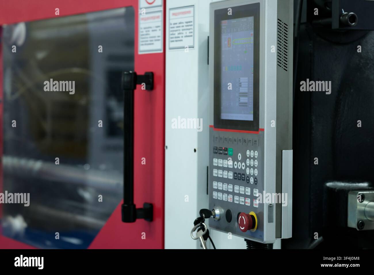 Injection molding machine with CNC control panel. Selective focus. Stock Photo