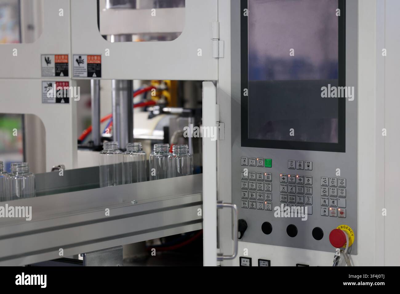 Automatic small plastic bottle making machine close up. Selective focus. Stock Photo