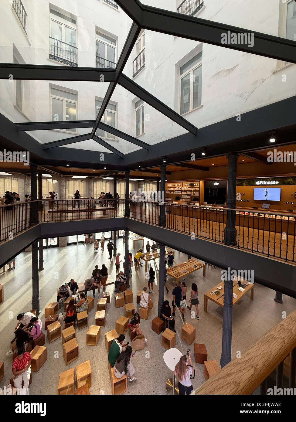 Visitors inside the Apple Store at Puerta del Sol in Madrid, Spain - Smartphone Captured Stock Image
