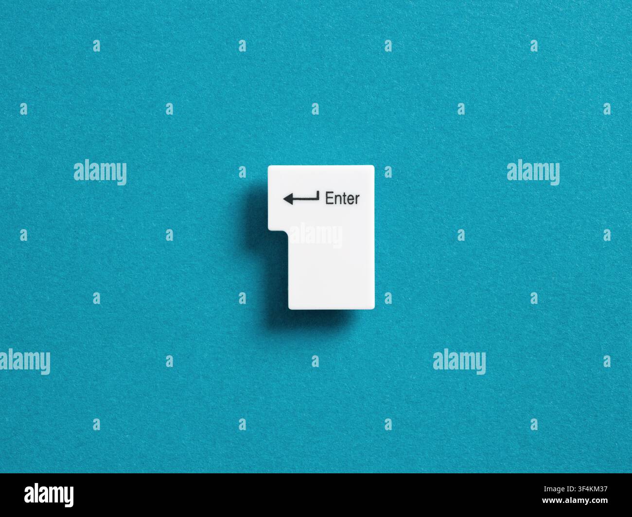Computer Enter button, placed on a vibrant blue background, representing connection, access, confirmation, digital execution, and login concepts Stock Photo