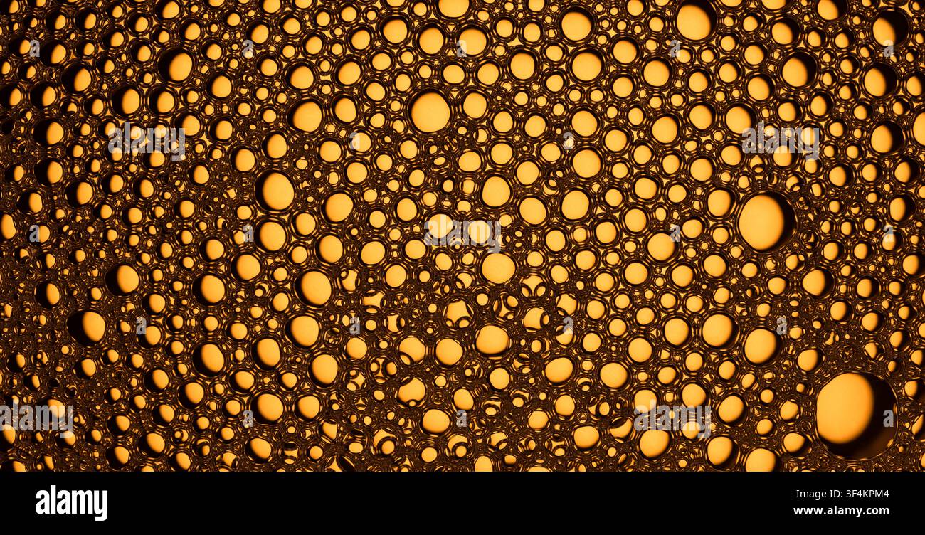 Macro view of connected golden bubbles creating an abstract pattern Stock Photo