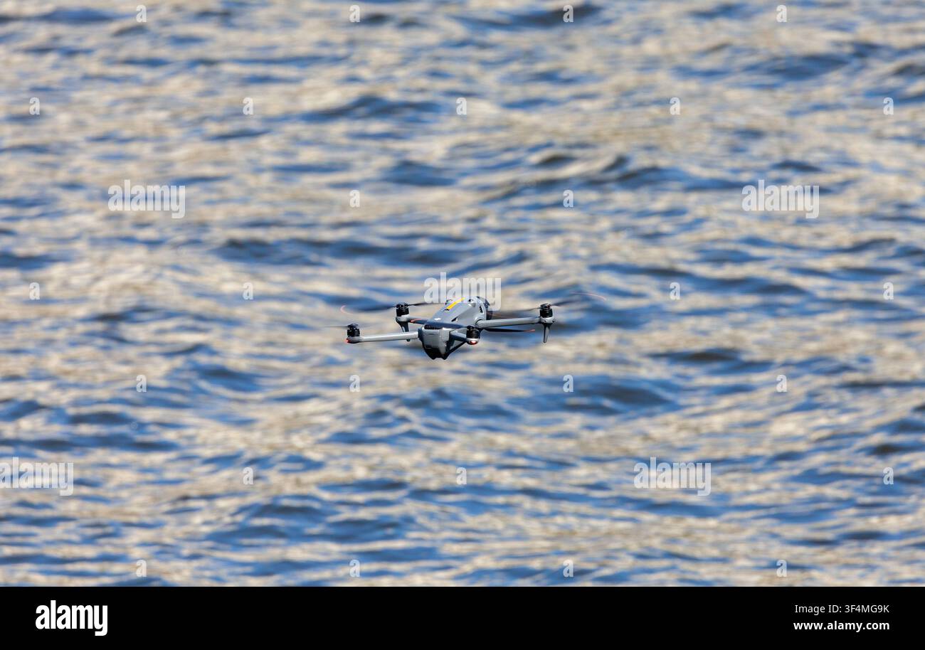 hobby drone flying over water Stock Photo