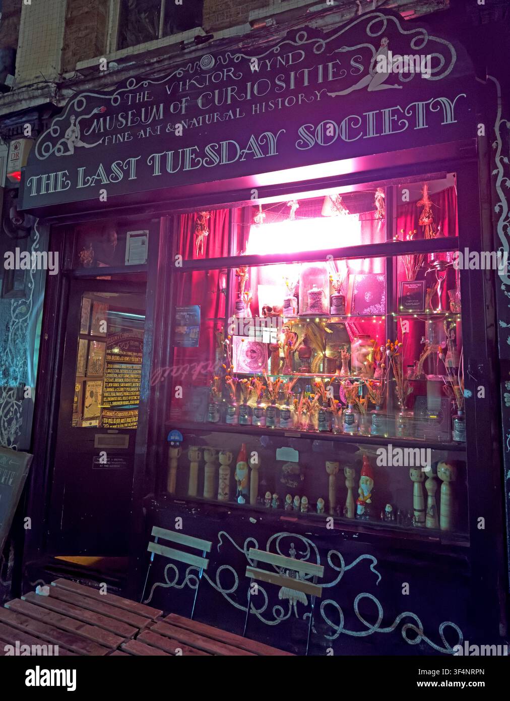 The Last Tuesday Society and Viktor Wynd Museum of Curiosities illuminated purple at night on Mare Street, Hackney, East London. Stock Photo