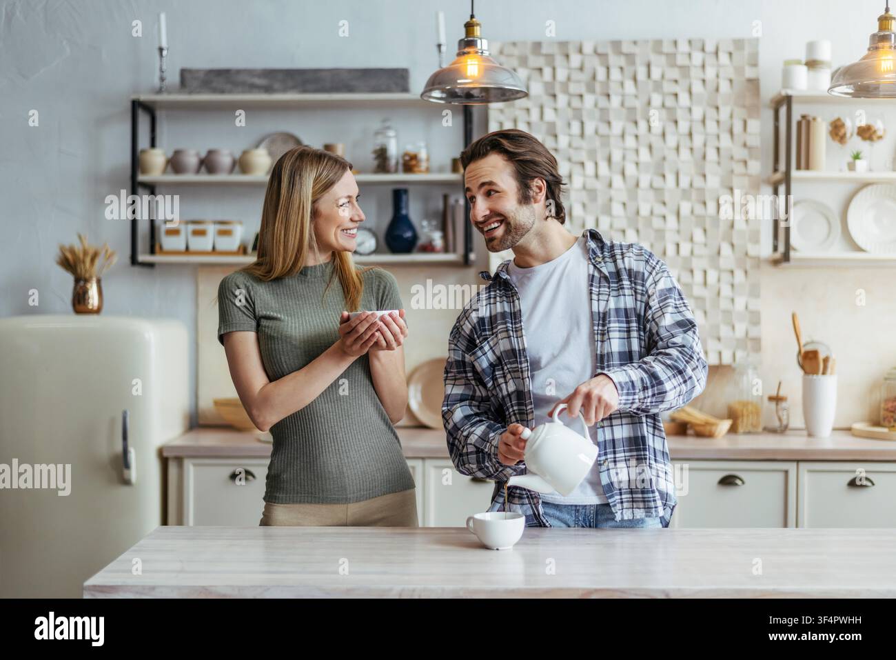 Happy Caucasian Couple Preparing Breakfast Together In Kitchen, Smiling Stock Photo