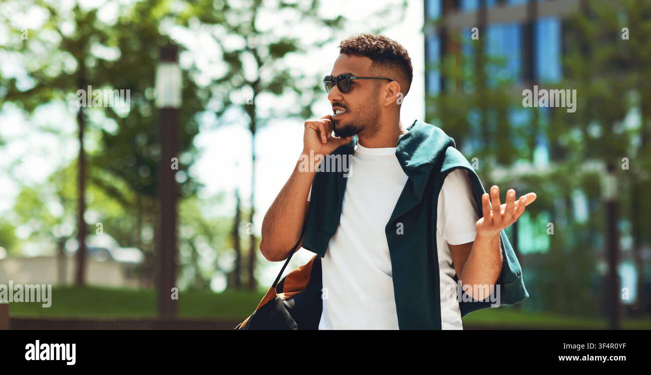 Young Man Talking On Phone With Expression Outdoors, Business Concept Stock Photo