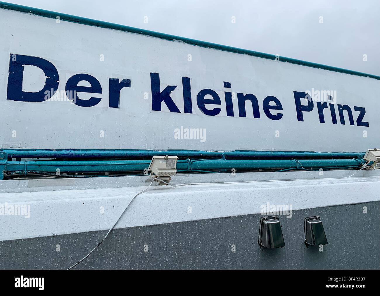 Named hull of cruise ship DER KLEINE PRINZ, Danube River (the old ship served as floating emergency shelters or temporary housing for asylum seekers) - Smartphone Captured Stock Image