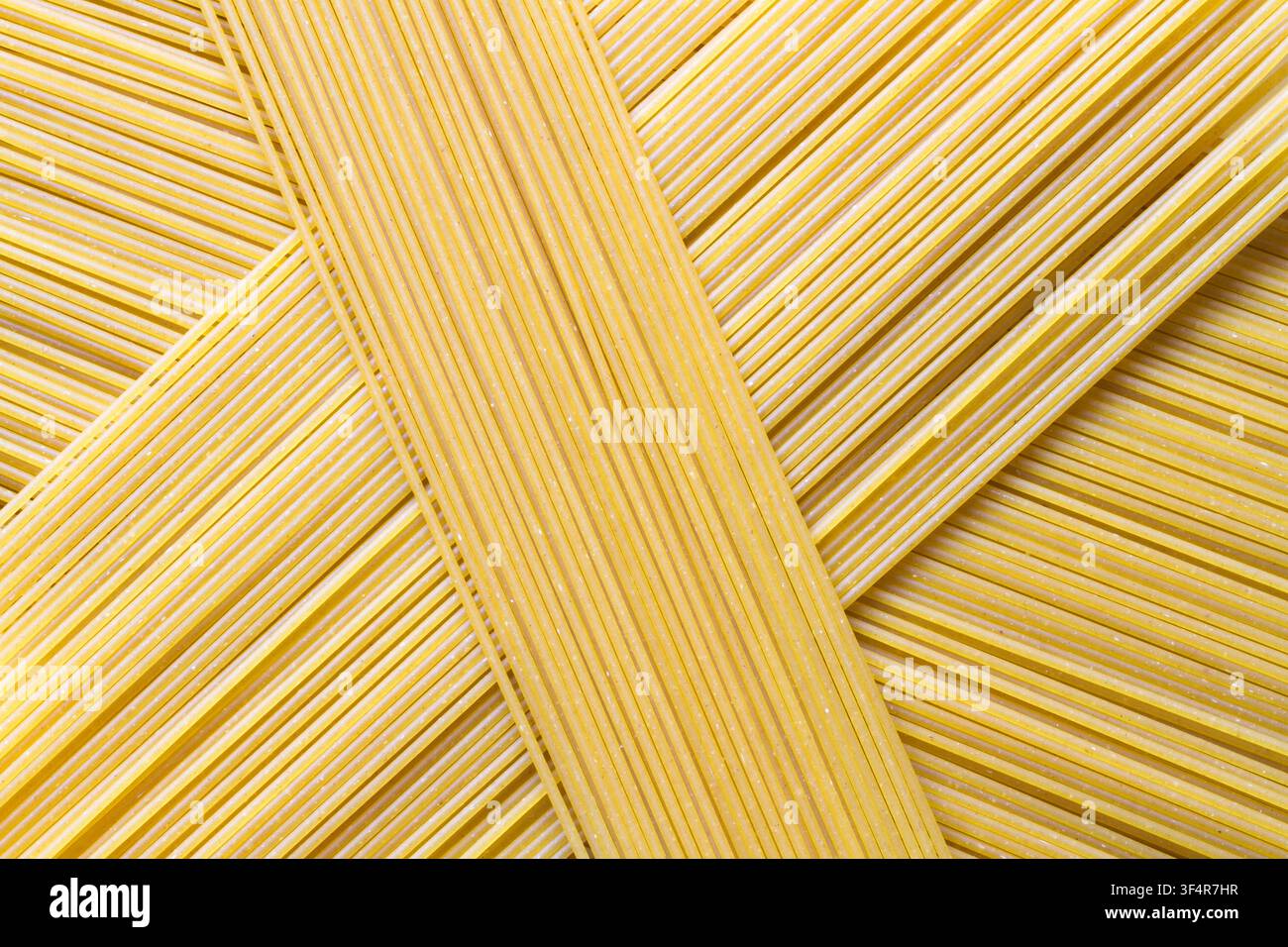 Spaghetti texture. Background texture of pasta. Raw spaghetti close-up. Stock Photo
