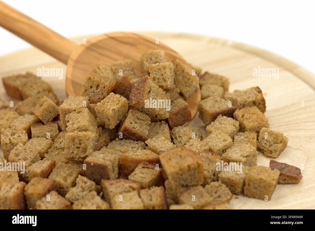 Toasted bread cubes against white background Stock Photo