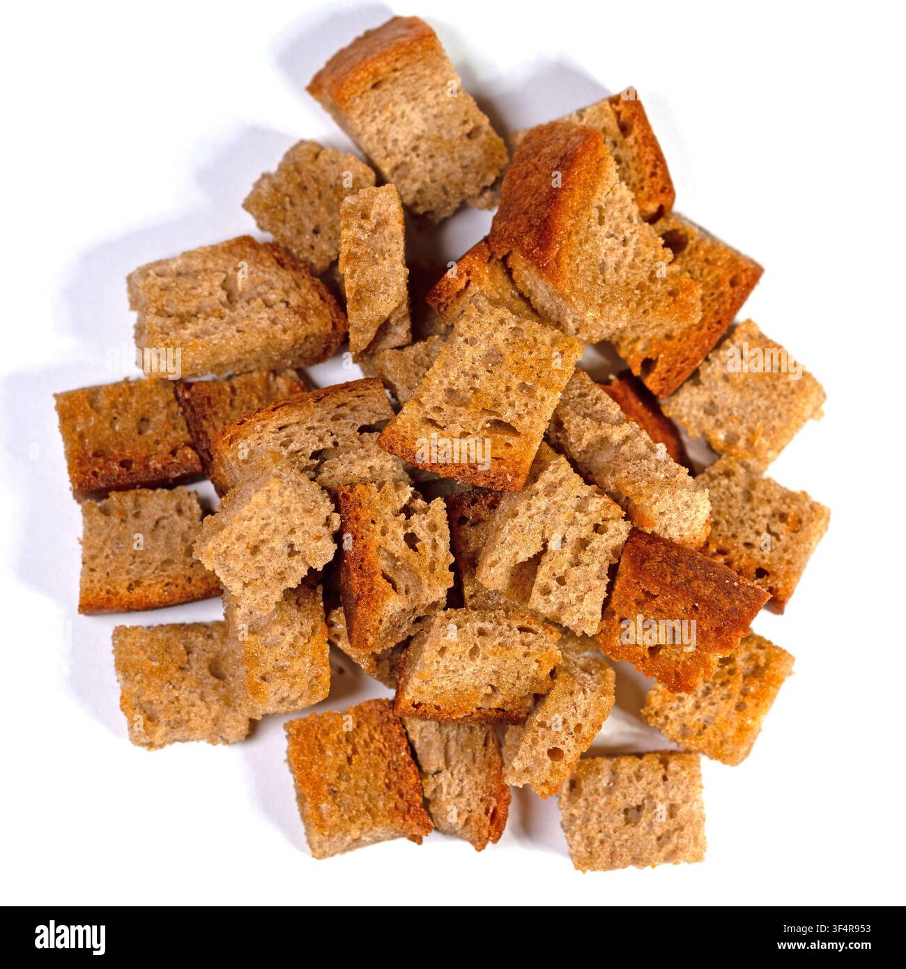Toasted bread cubes against white background Stock Photo