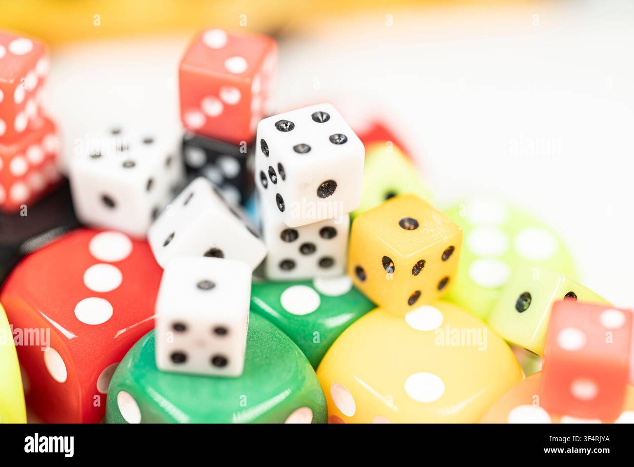 Scattered multicolored playing pieces used for tabletop games and probability learning Stock Photo