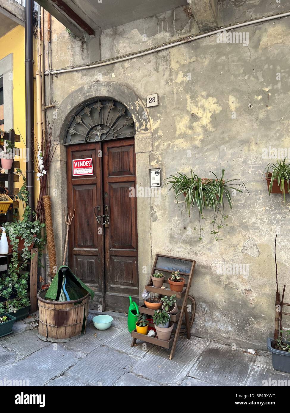 Medieval alley stone arch, cobblestone street and flower decorations in Lovere, Lake Iseo, Lombardy, Italy. - Smartphone Captured Stock Image