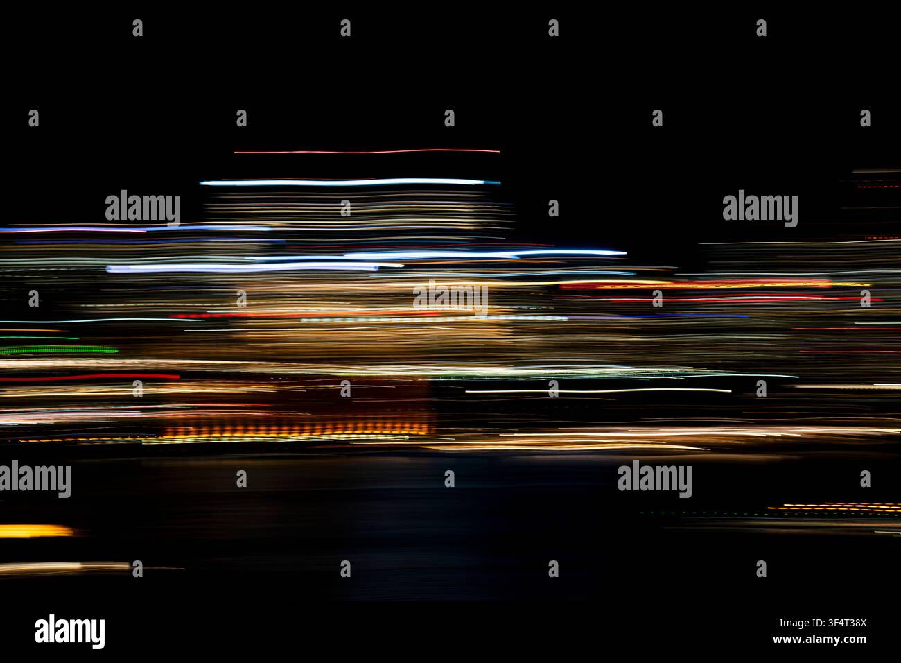 Horizontal light trails on dark background Stock Photo
