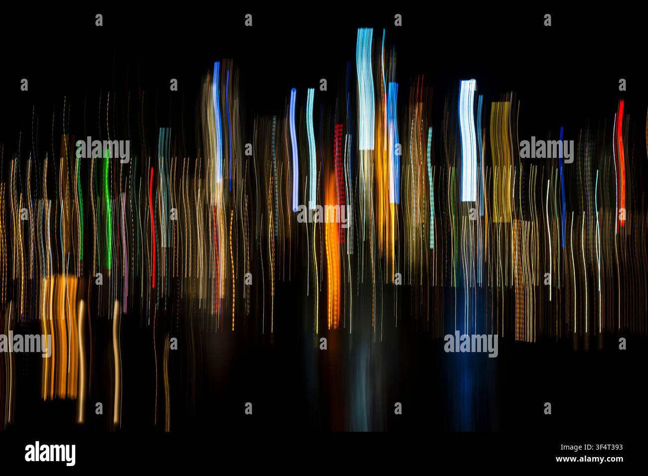 Vertical light trails on dark background Stock Photo