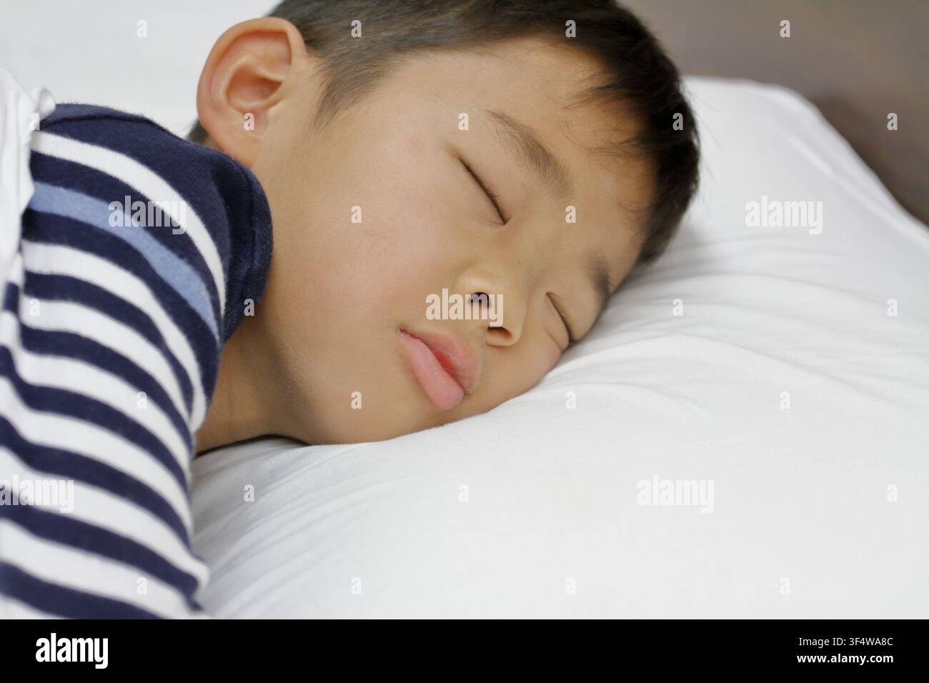 sleeping Japanese boy (third grade at elementary school) Stock Photo