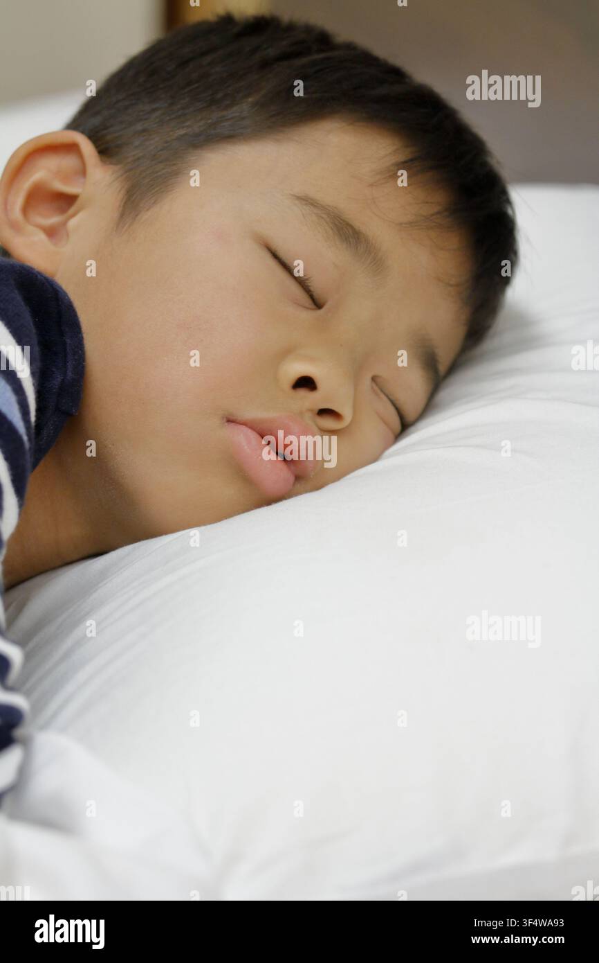 sleeping Japanese boy (third grade at elementary school) Stock Photo