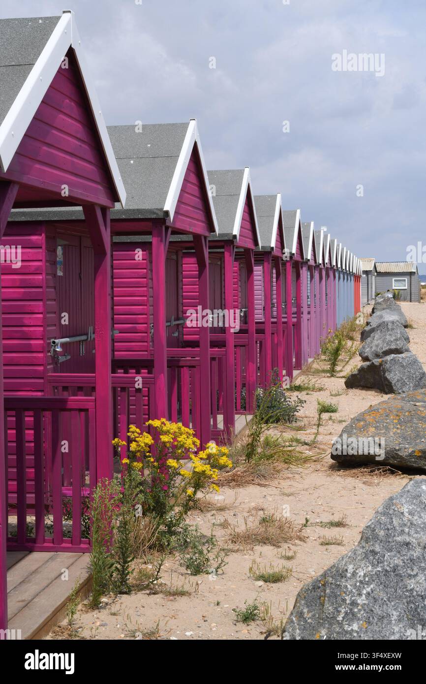 Beach huts on a sandy beach Stock Photo
