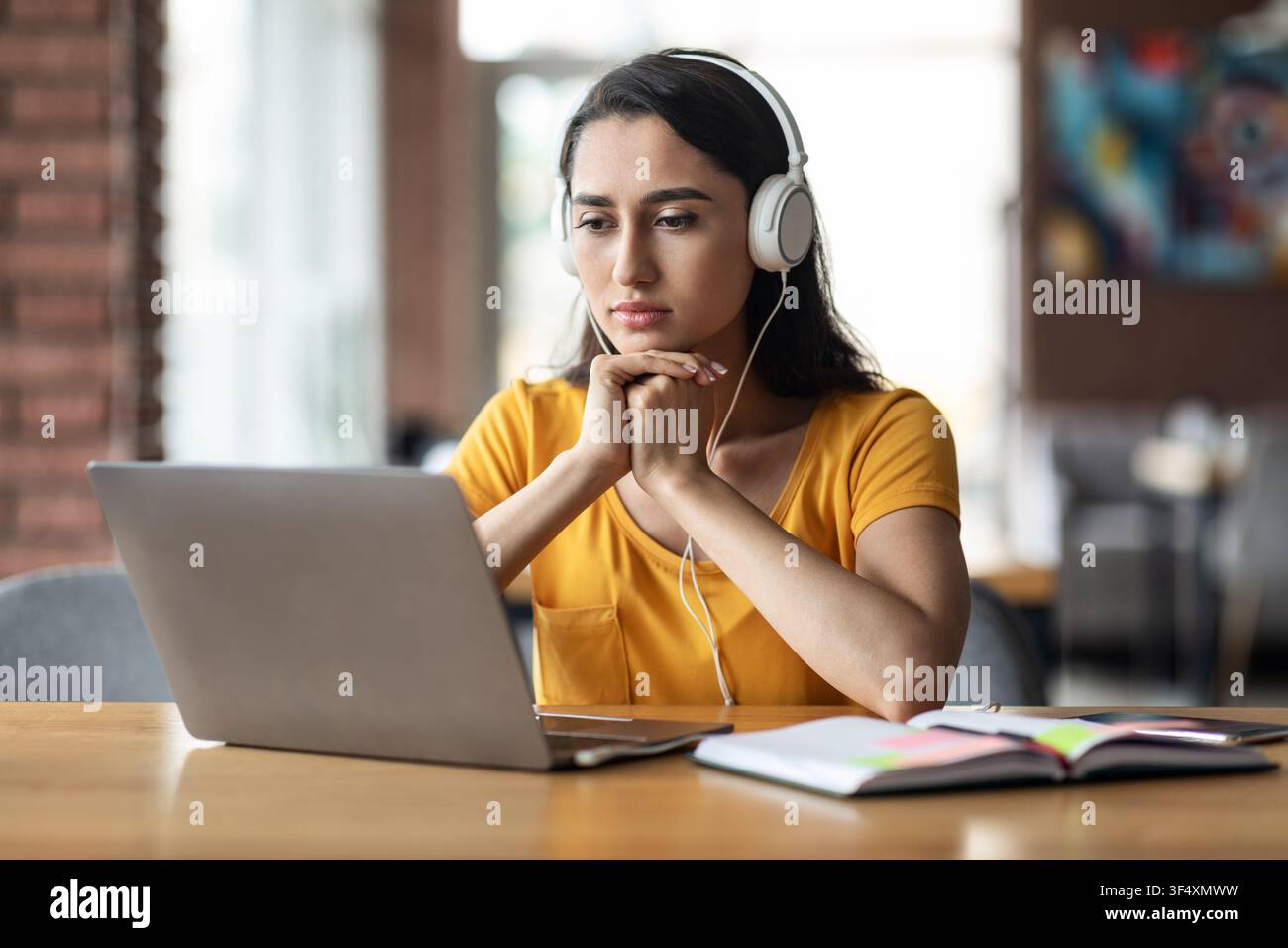 Concentrated young arab lady having educational course online Stock Photo
